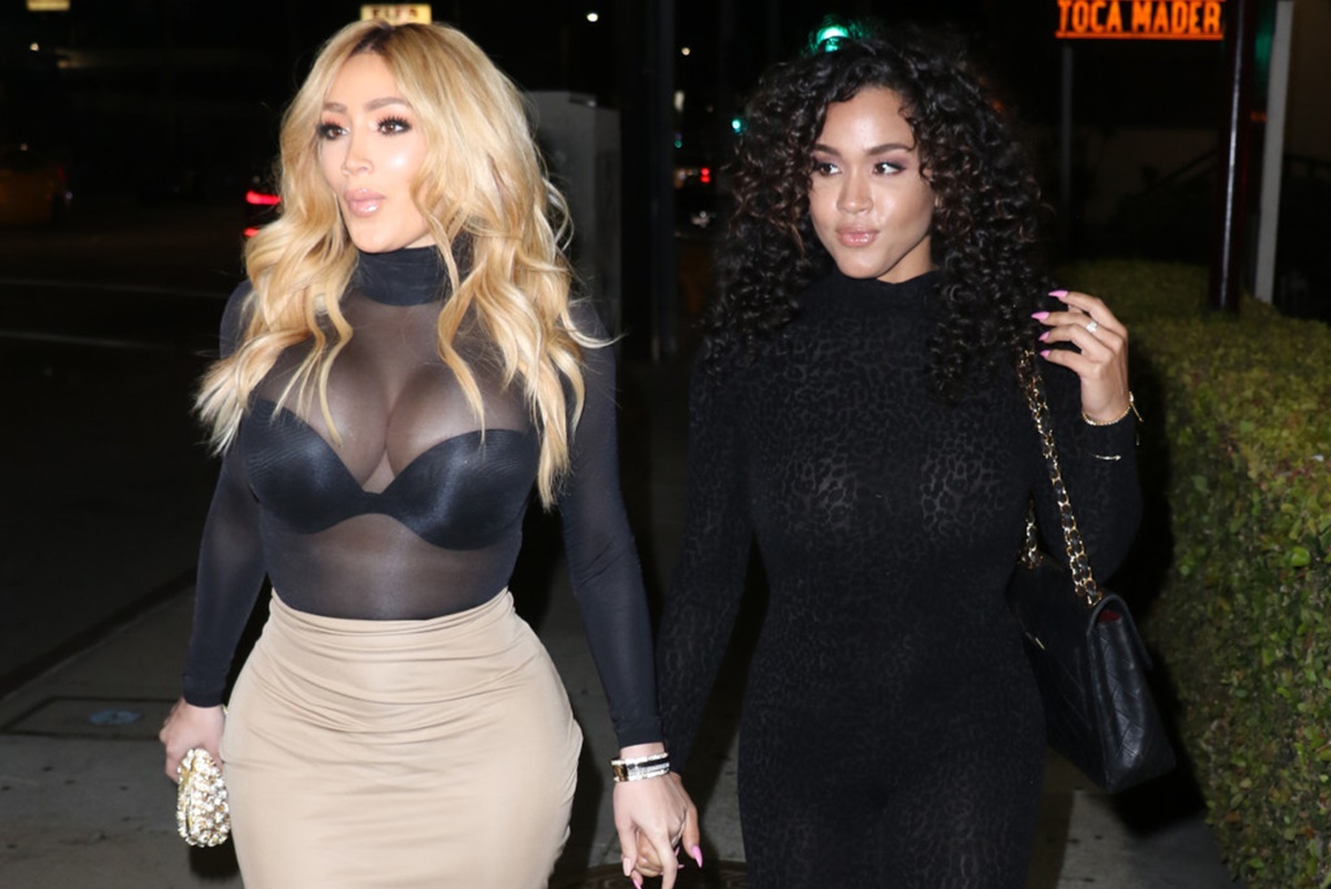 Nikki Mudarris and Rosa Acosta hold hands and share a kiss while heading to...